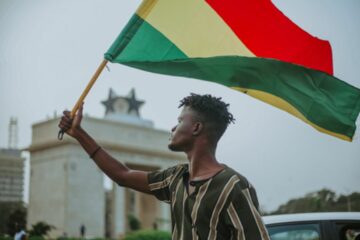 person waving a Ghanaian flag