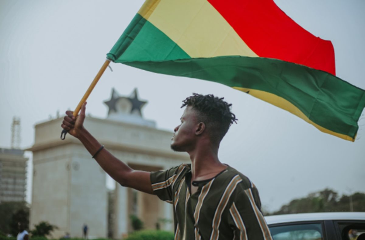 person waving a Ghanaian flag